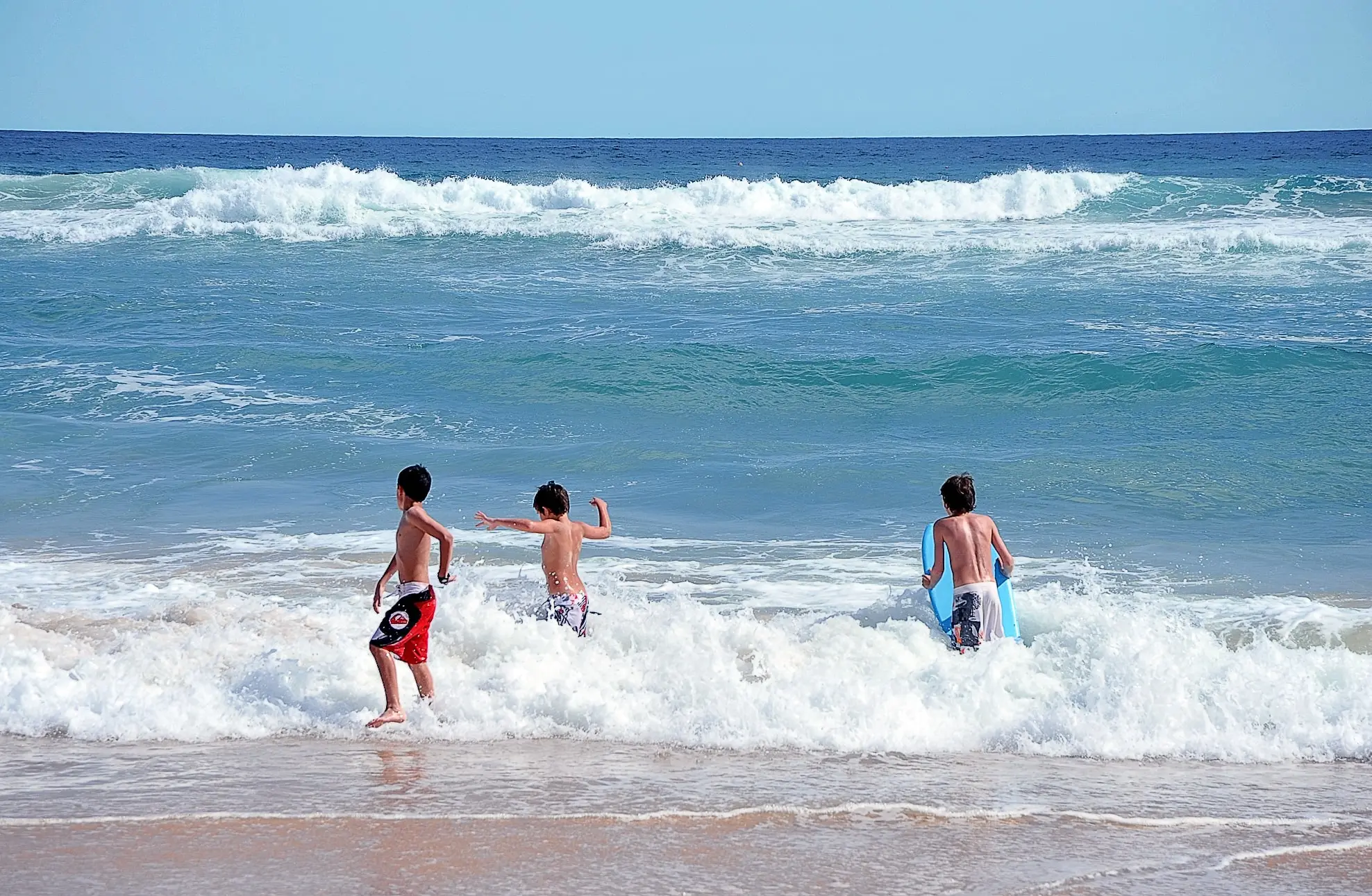 Kids playing on the beach in Algarve